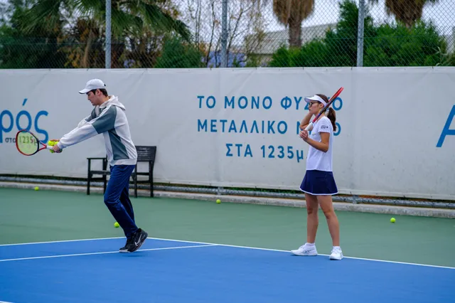 A coach working with a player on court
